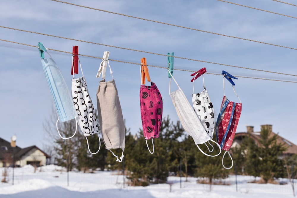 assorted clothes hanging on clothes line