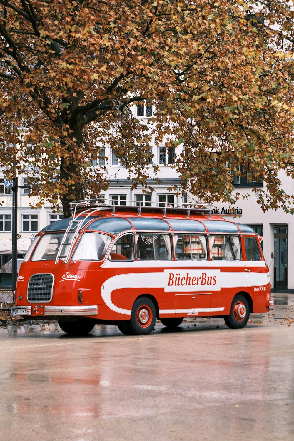 red and white volkswagen t-2 parked on sidewalk during daytime