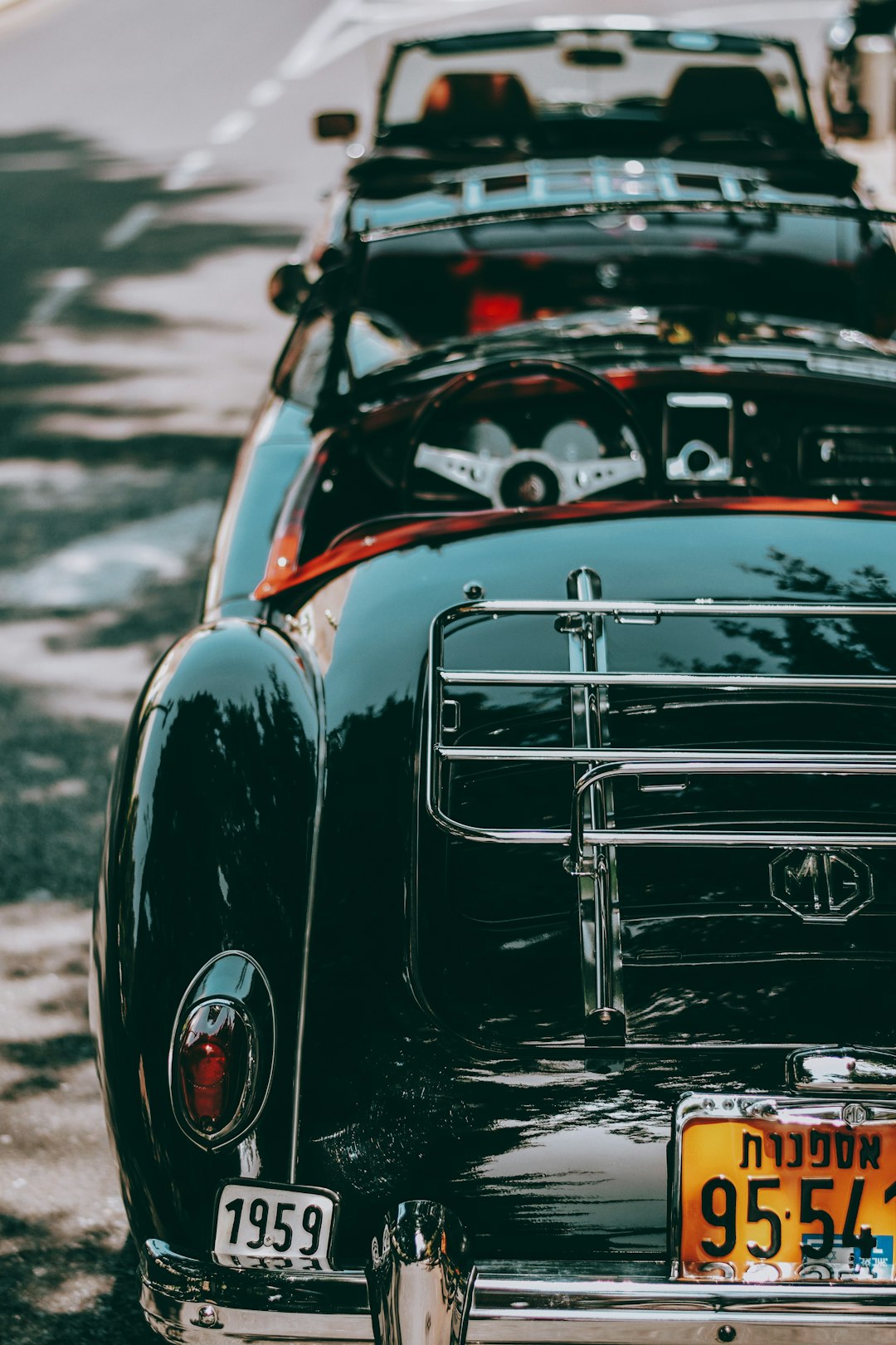 black car on gray asphalt road during daytime