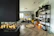 A stylish living room featuring grey walls and golden decorative elements.