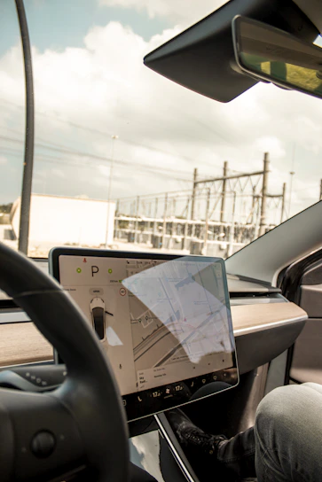 A modern vehicle tracking control center with multiple screens displaying live GPS data.