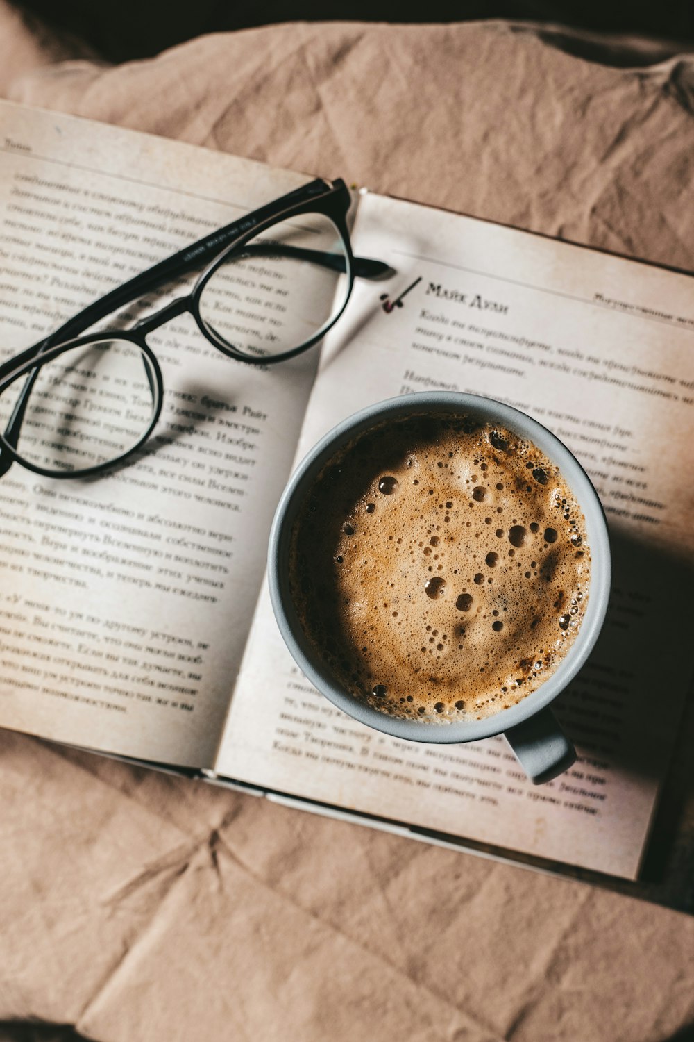 black framed eyeglasses on white printer paper