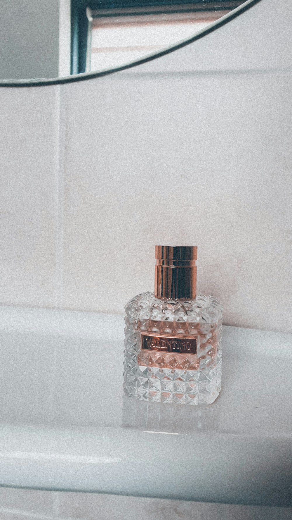 clear glass bottle on white table