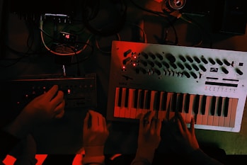 person holding white and black audio mixer