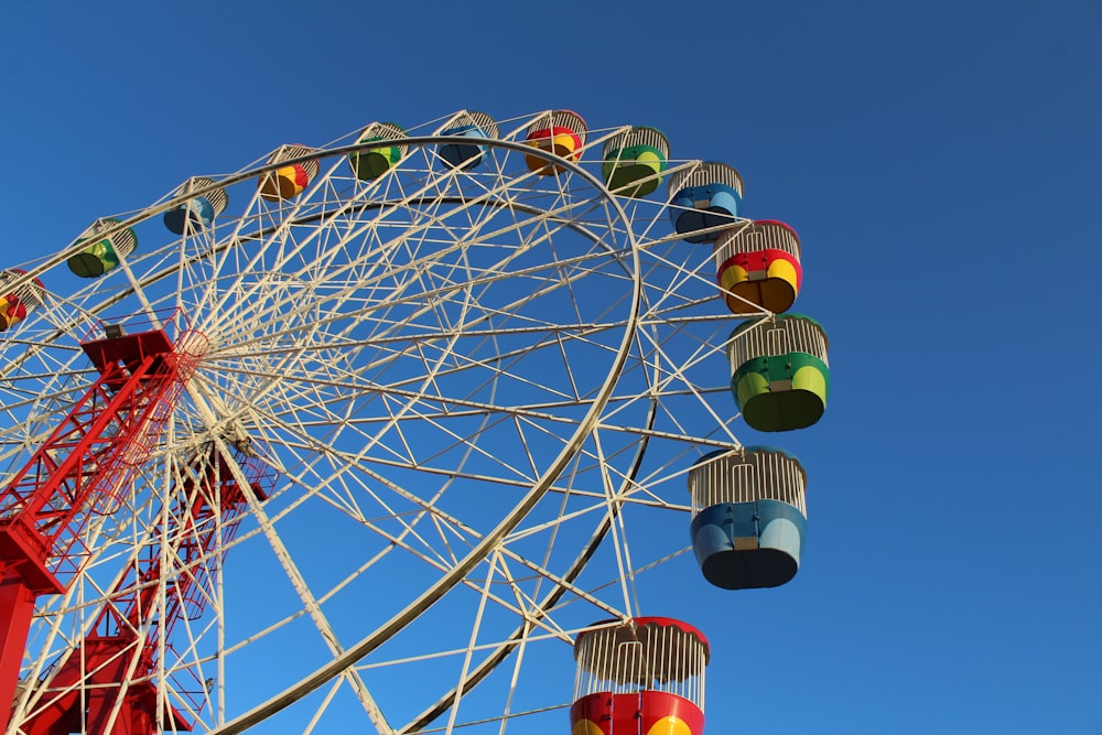 white and red ferris wheel under blue sky during daytime