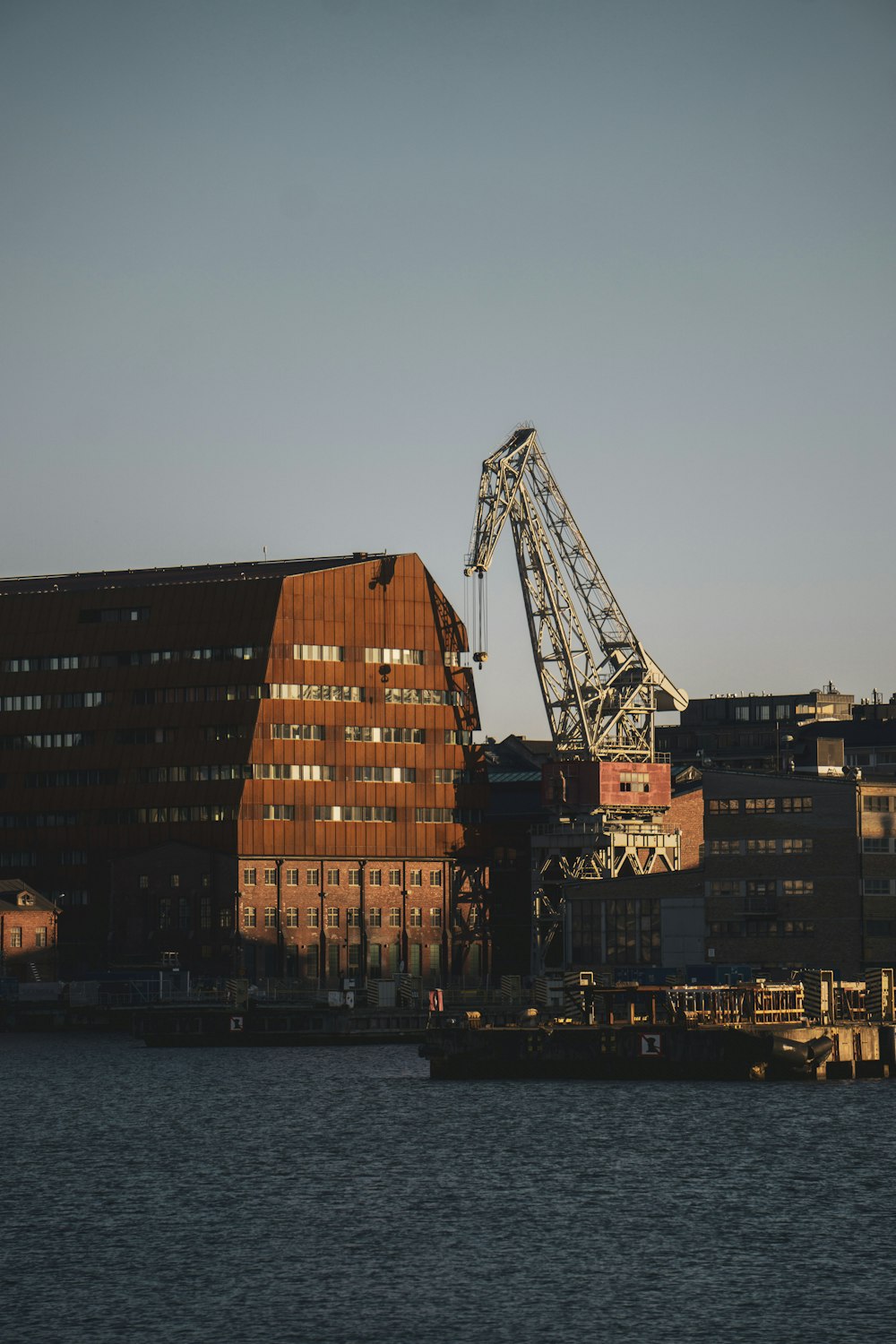 brown concrete building near body of water during daytime