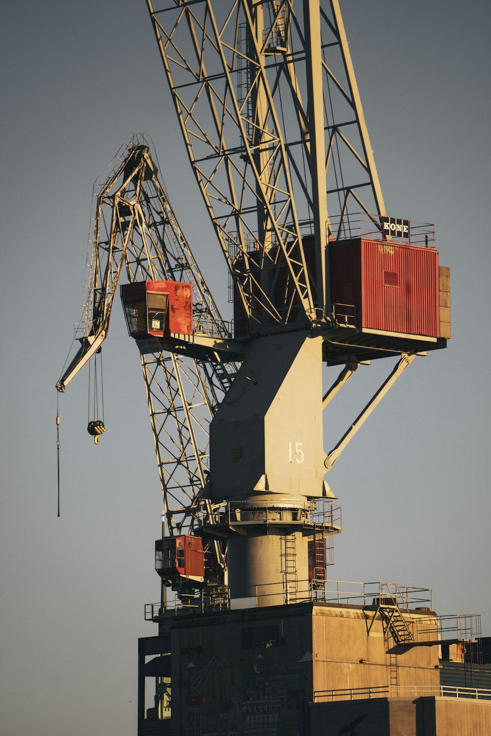 white and red crane under blue sky during daytime