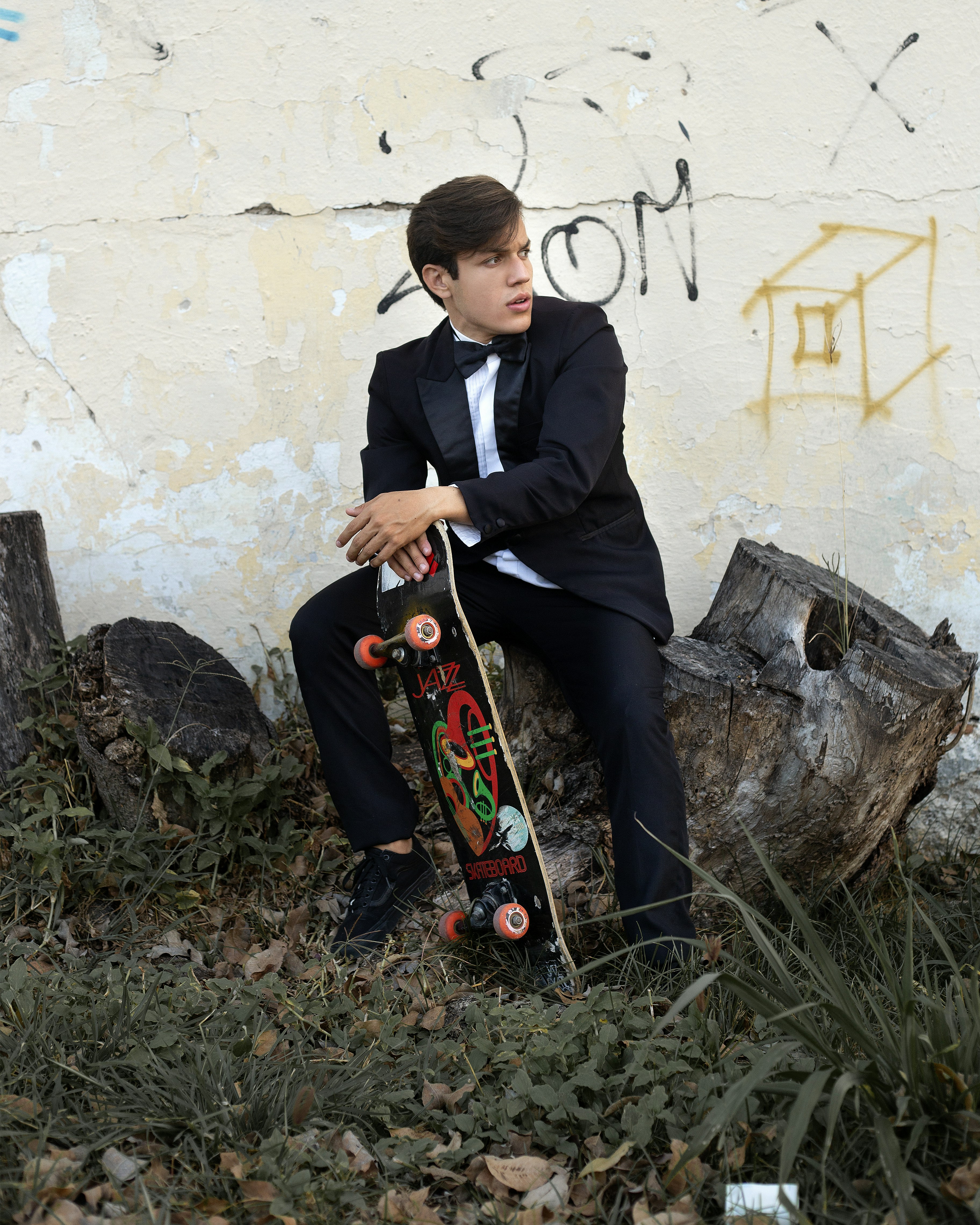 man in black suit playing guitar