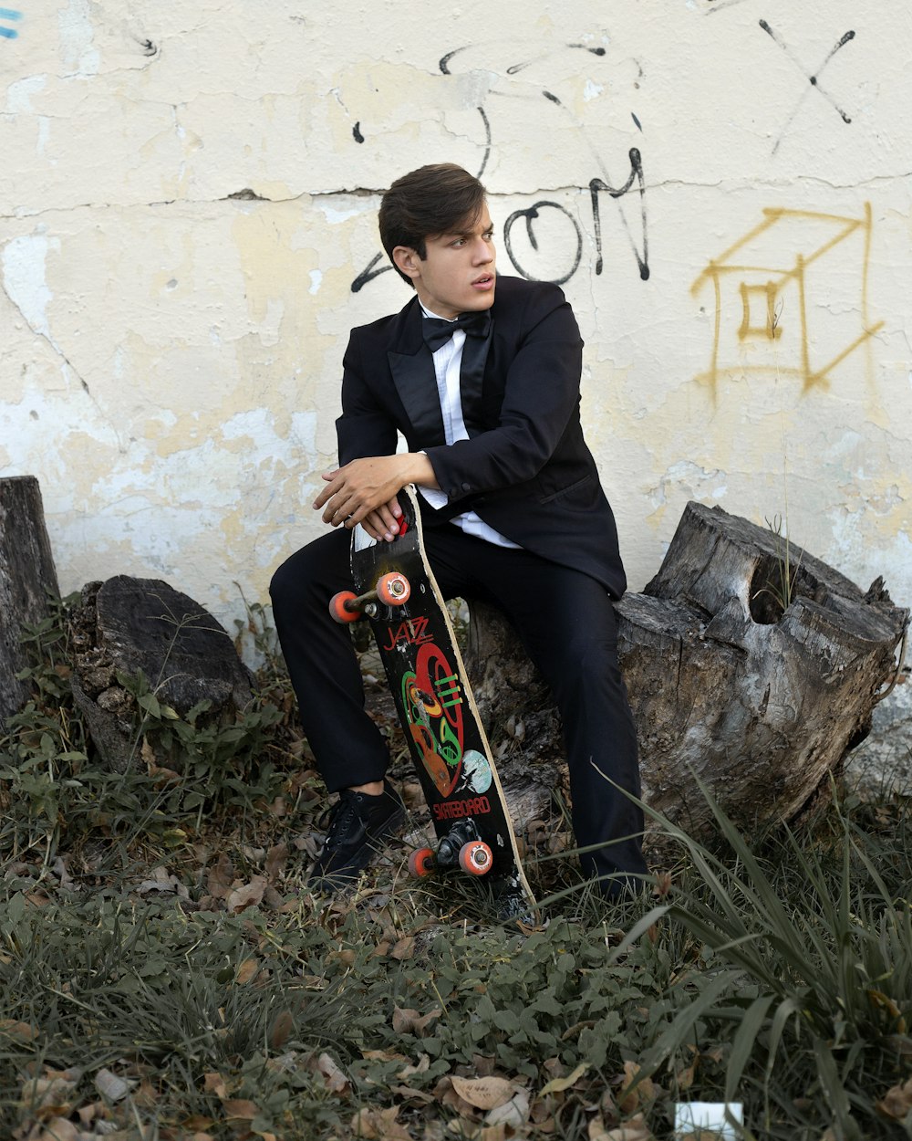 man in black suit playing guitar