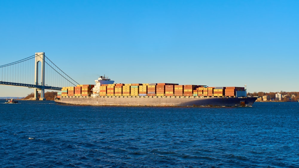 brown cargo ship on sea under blue sky during daytime