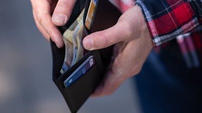 person holding black and orange box