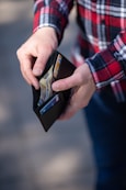 person holding black and orange box