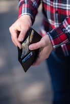 person holding black and orange box
