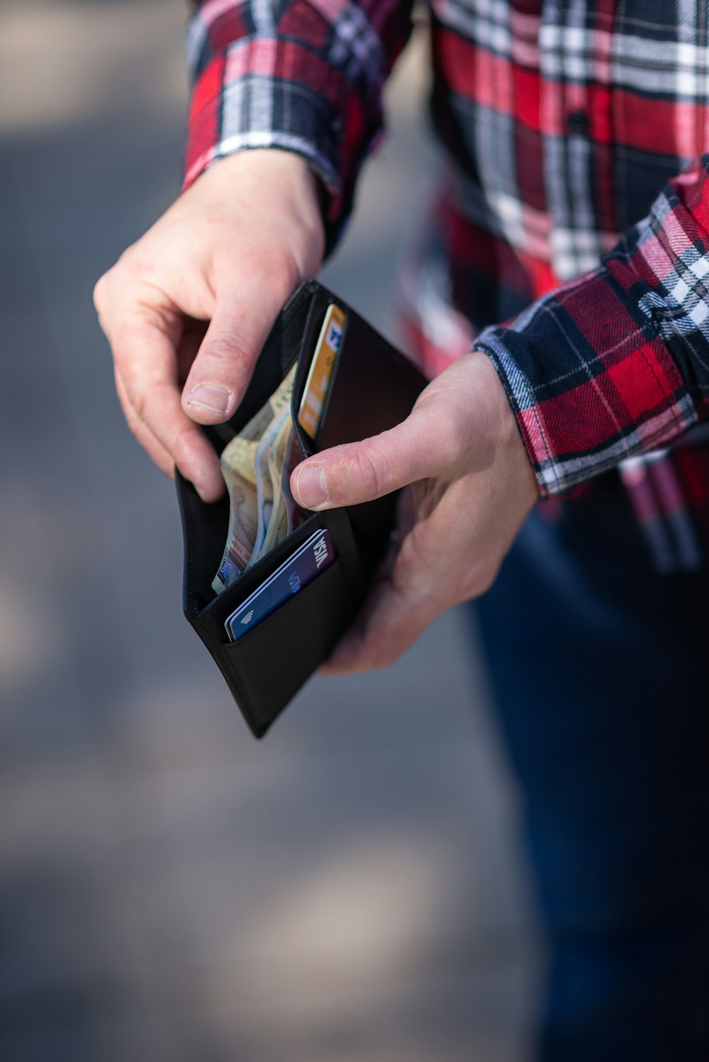 person holding black and orange box