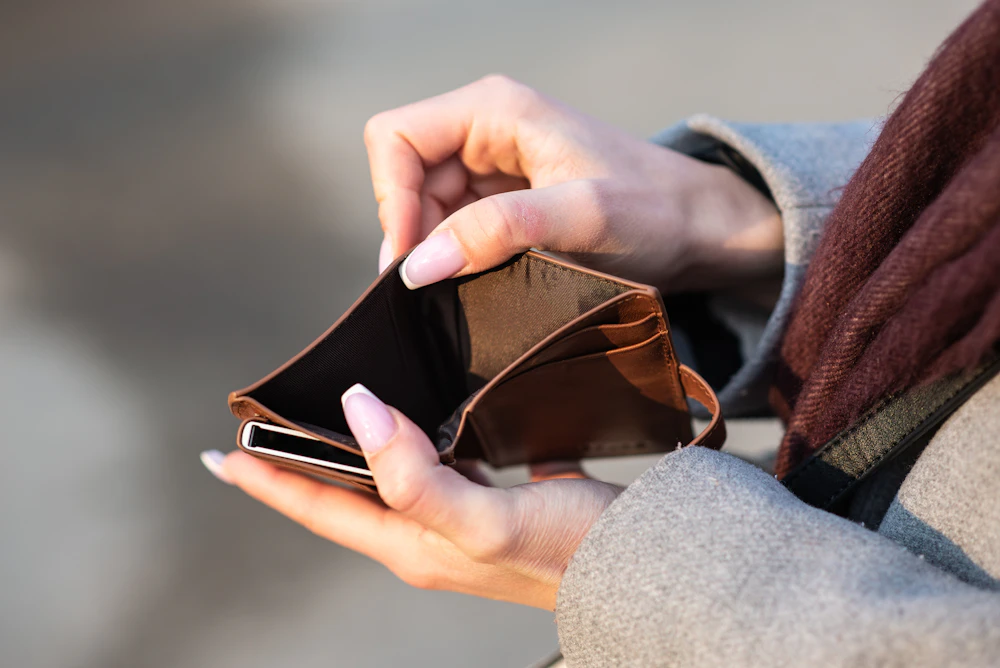 Hands holding an open, empty wallet