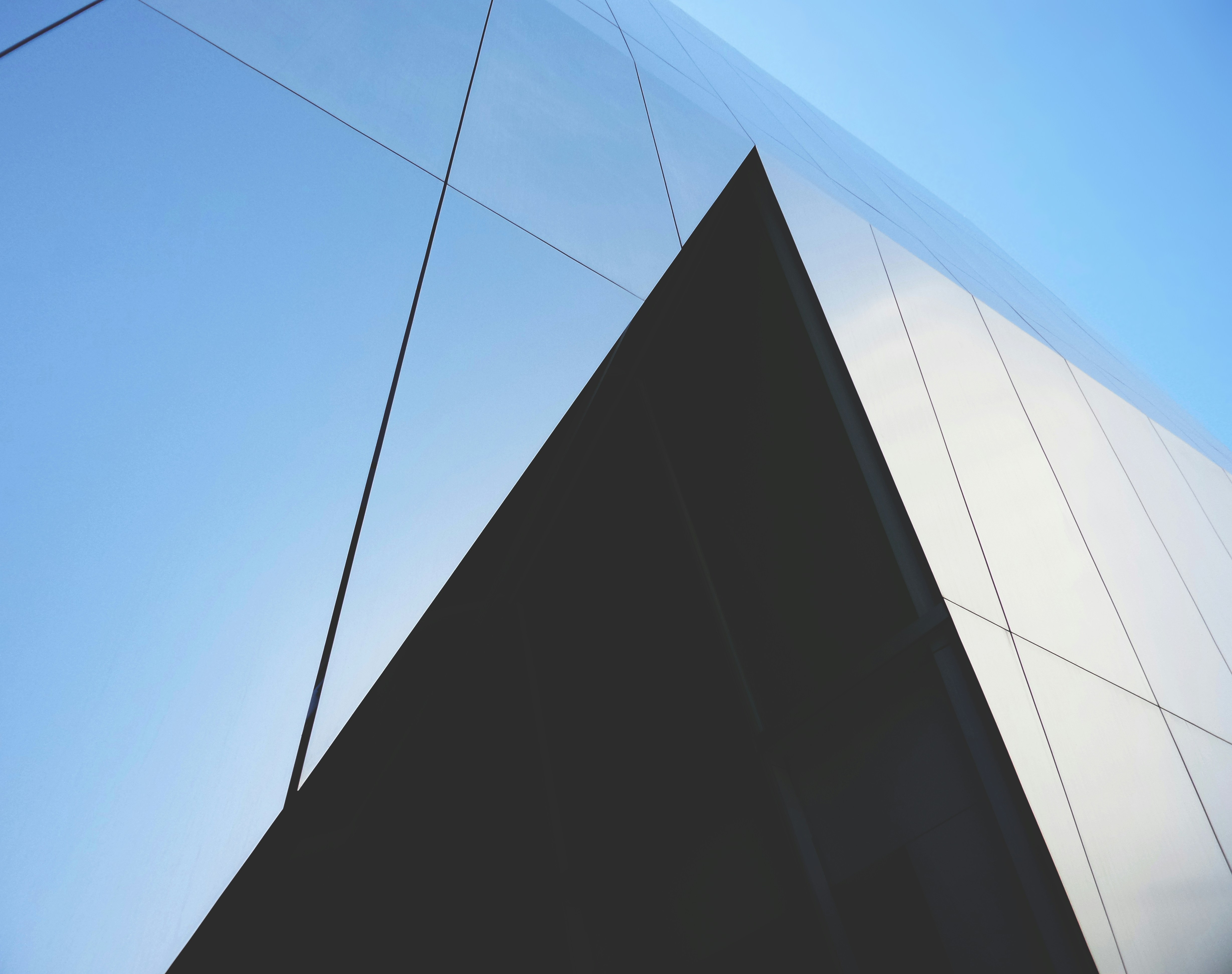 black and white concrete building under blue sky during daytime