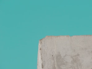 Close-up of a small concrete product with natural linen fabric background and Baltic symbols.