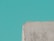 A textured, roughly cut piece of concrete or stone appears in the lower part of the image against a solid teal background.