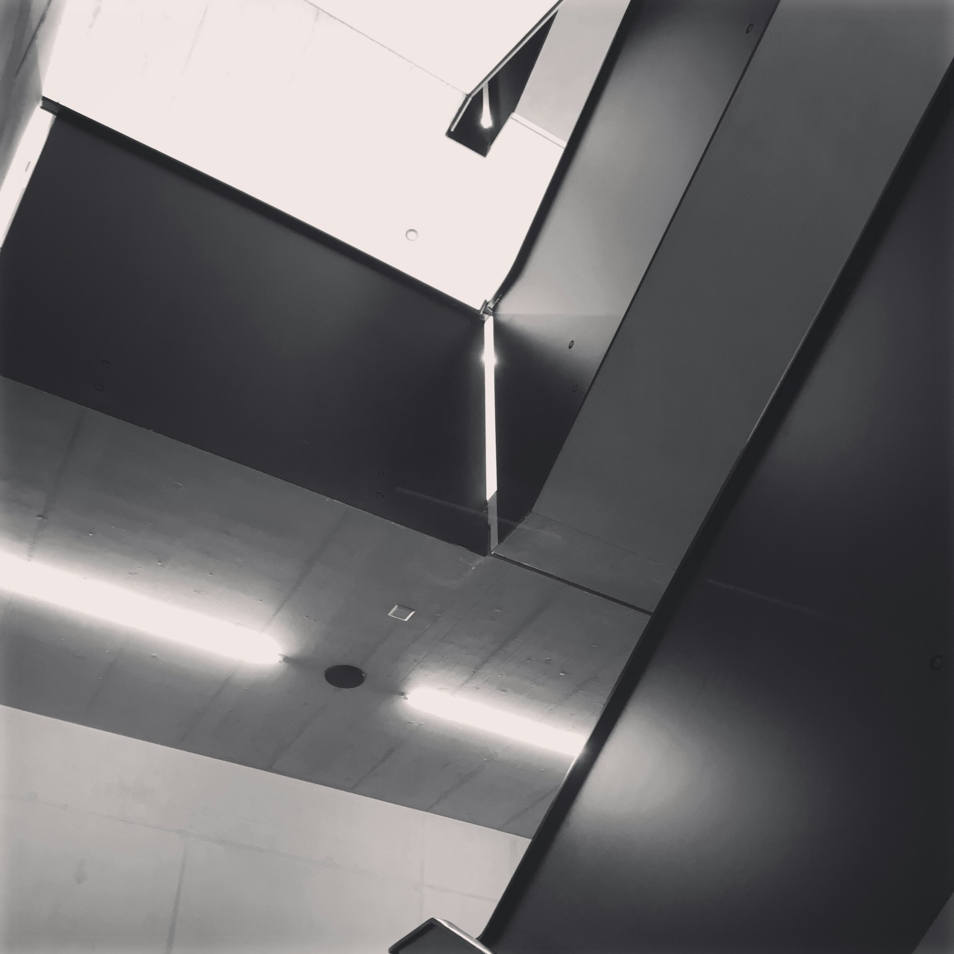 A minimalist architectural interior showcasing balanced light and shadow play on clean, precise lines.