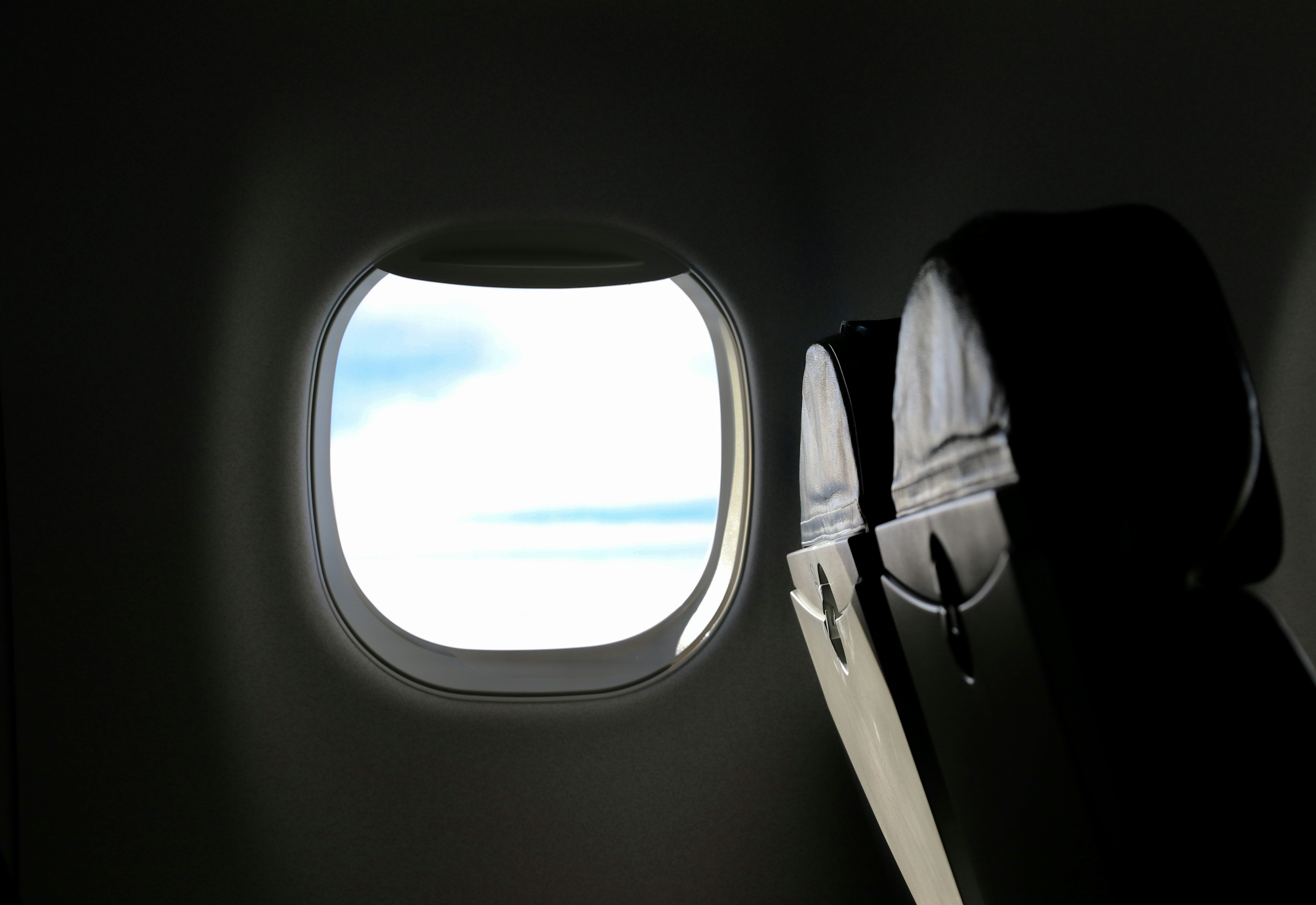 white airplane window during daytime, fasten your seatbelt and enjoy the view!