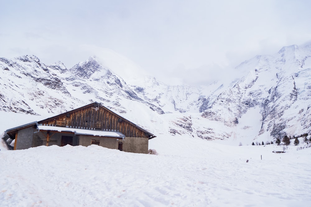 casa di legno marrone su terreno innevato