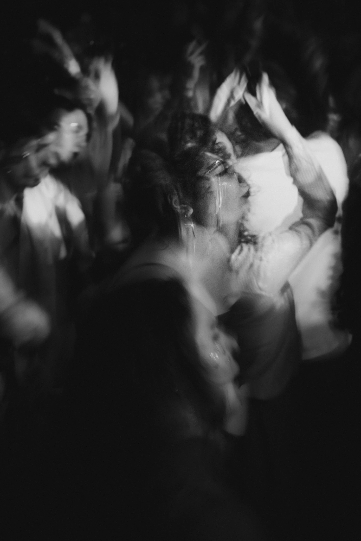 A crowded dance floor dragged into streaks by a slow shutter