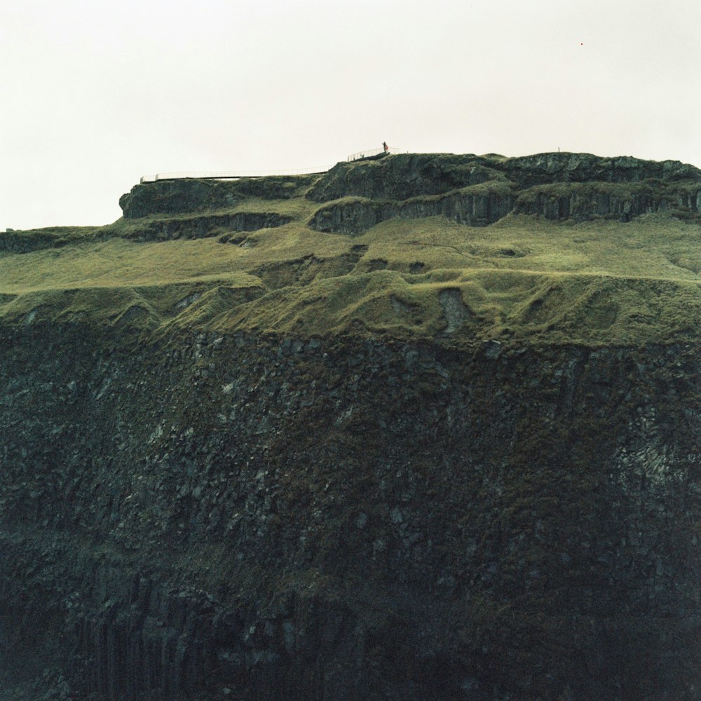 person standing on top of mountain during daytime