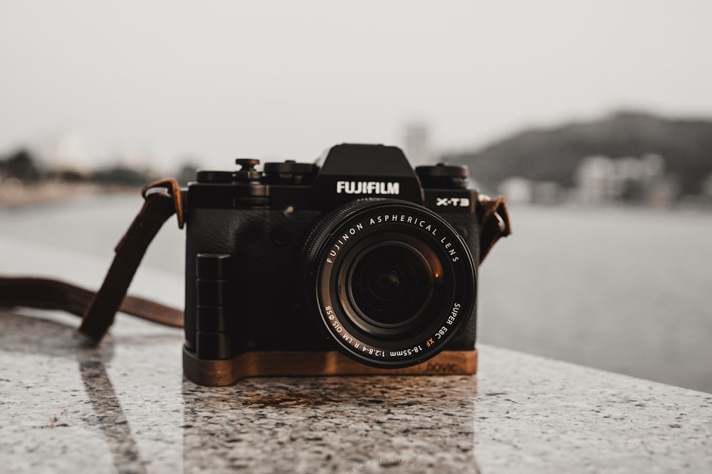 black nikon dslr camera on white table