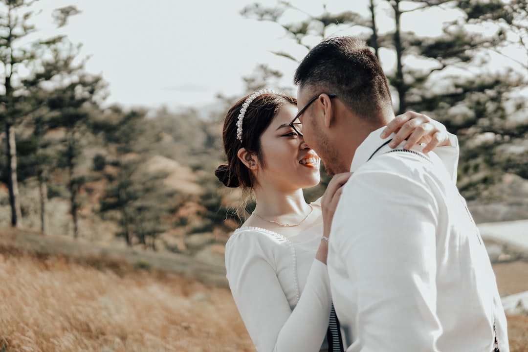 woman in white long sleeve shirt kissing man in white dress shirt