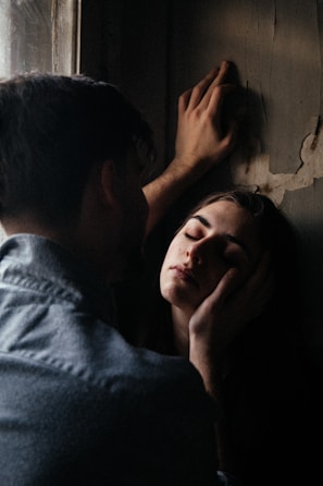 An intimate scene showing the two lovers reaching out to each other across a dimly lit room.