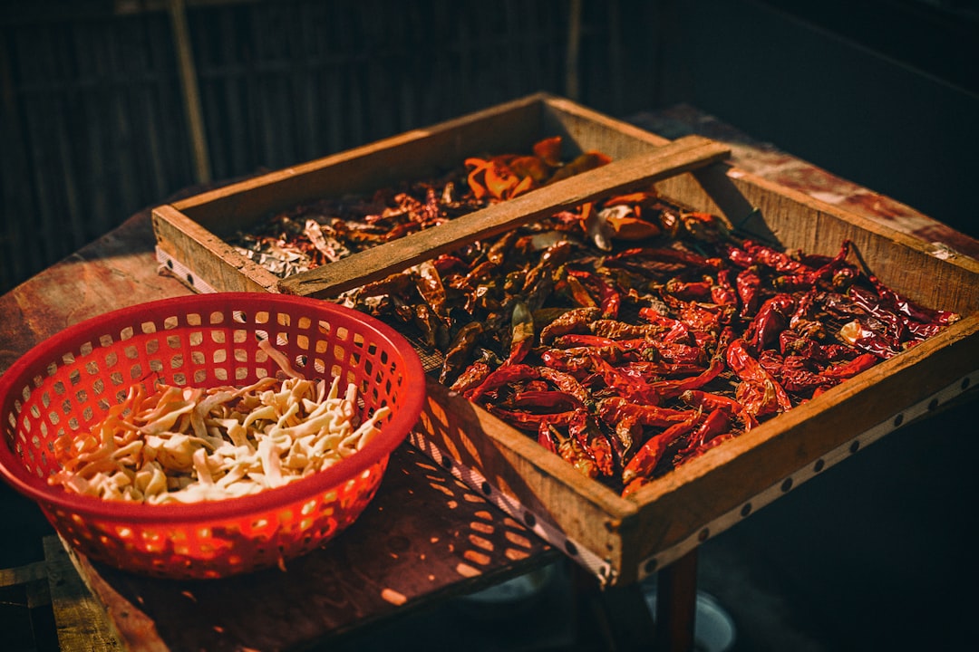 brown wooden crate with red chili