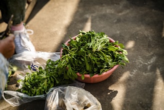 green and red chili on brown plastic basket