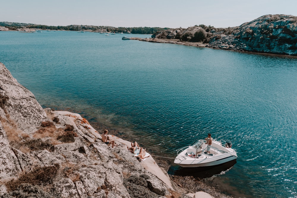 white and blue boat on sea during daytime