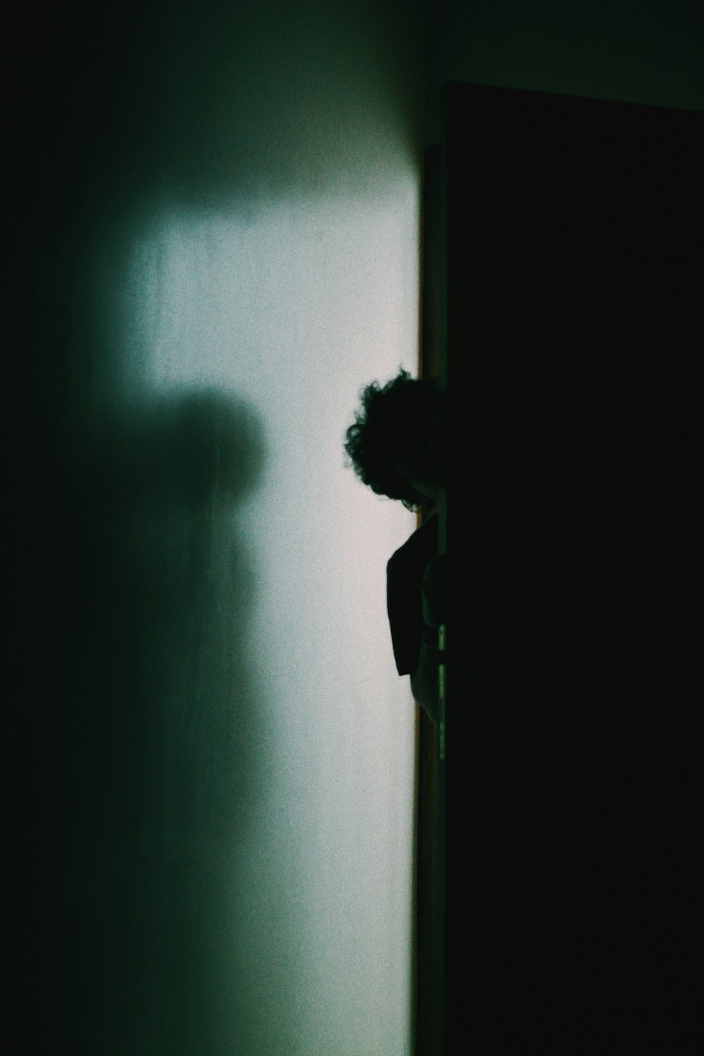 person in black shirt standing on gray concrete floor