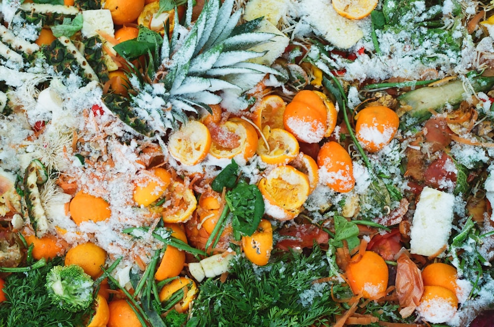 sliced orange fruits on green leaves