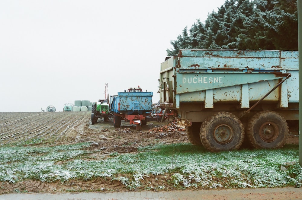 white and green utility truck on green grass field during daytime