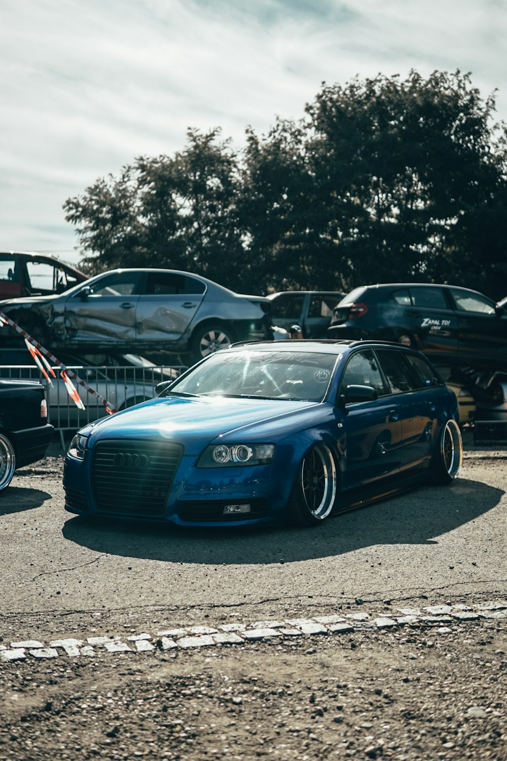 blue audi a 4 parked on parking lot during daytime