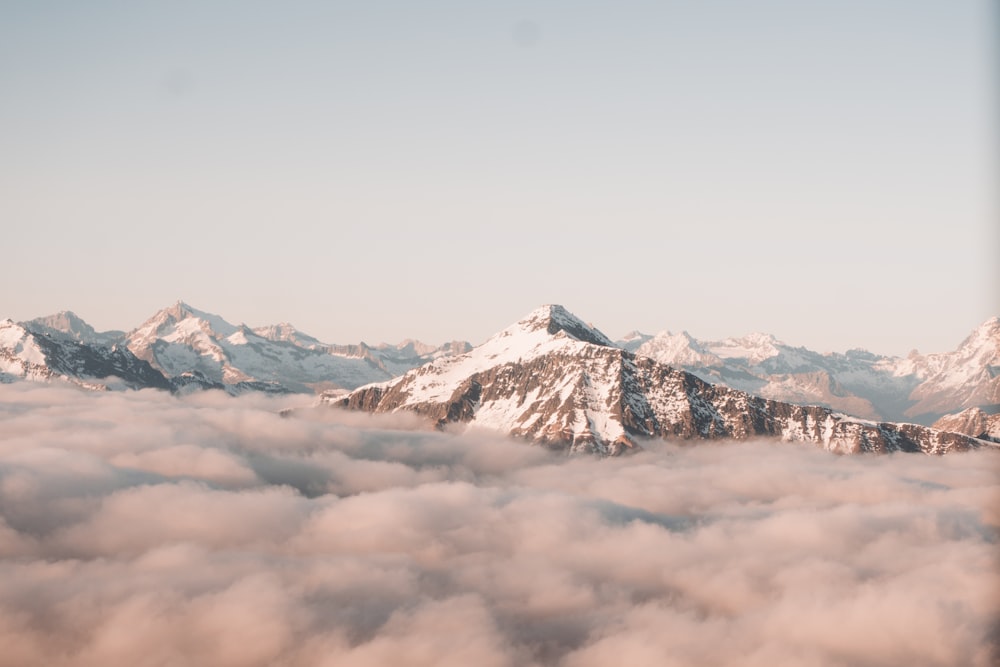 snow covered mountain under cloudy sky during daytime