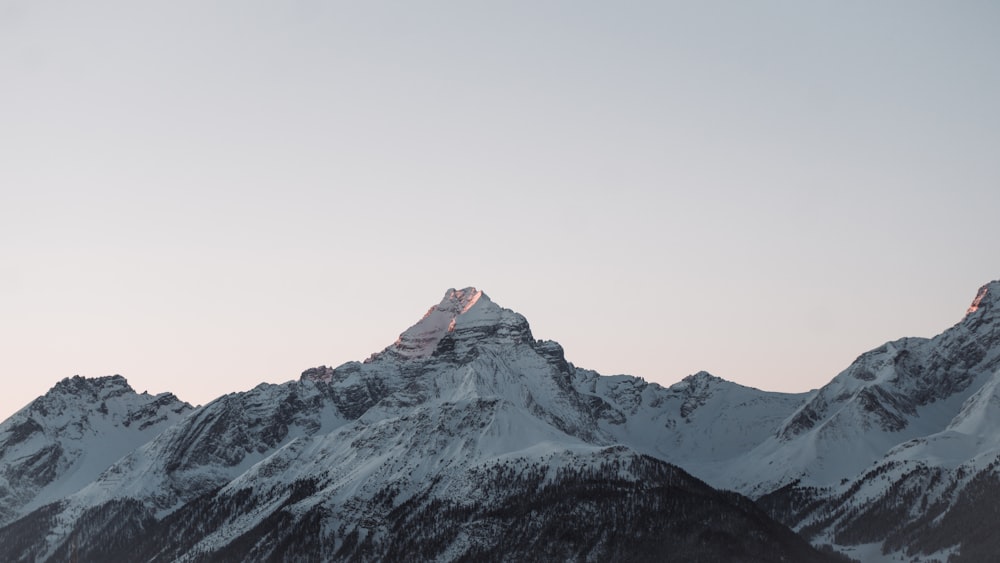 snow covered mountain under white sky during daytime