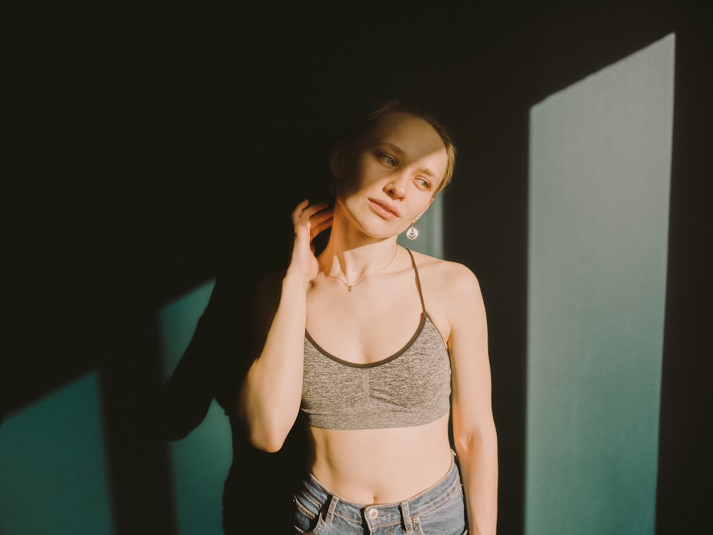 woman in gray spaghetti strap top and blue denim shorts