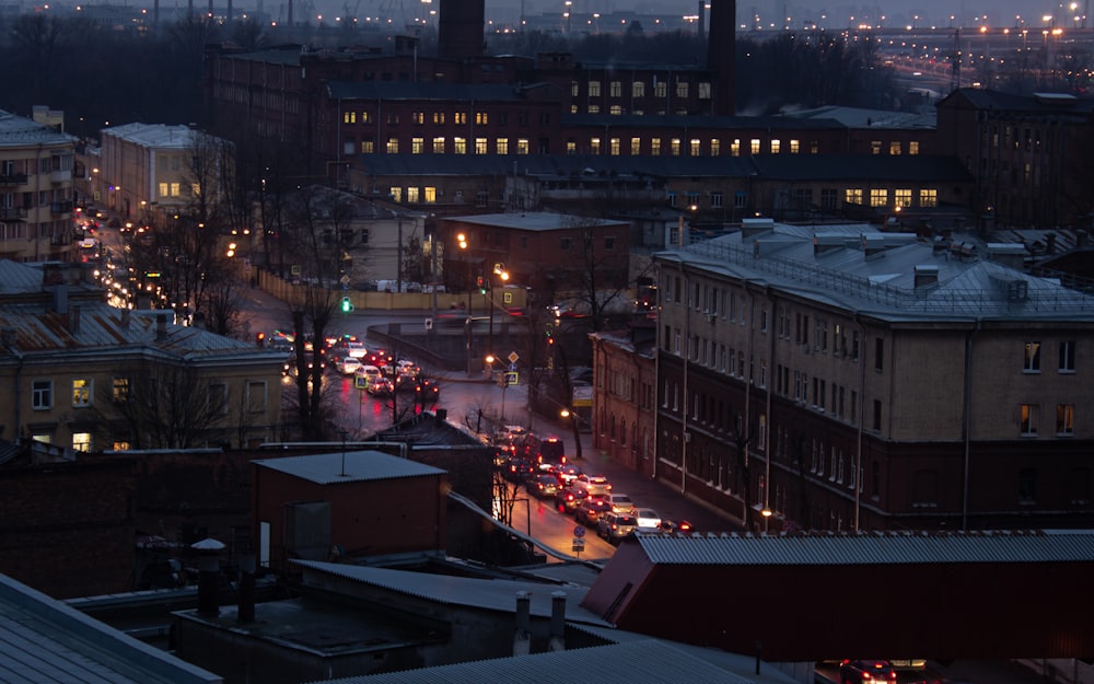 cars parked on the side of the road in front of a building during night time