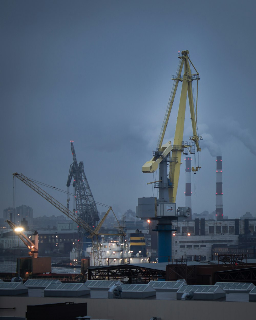 blue and white cargo ship on dock during daytime