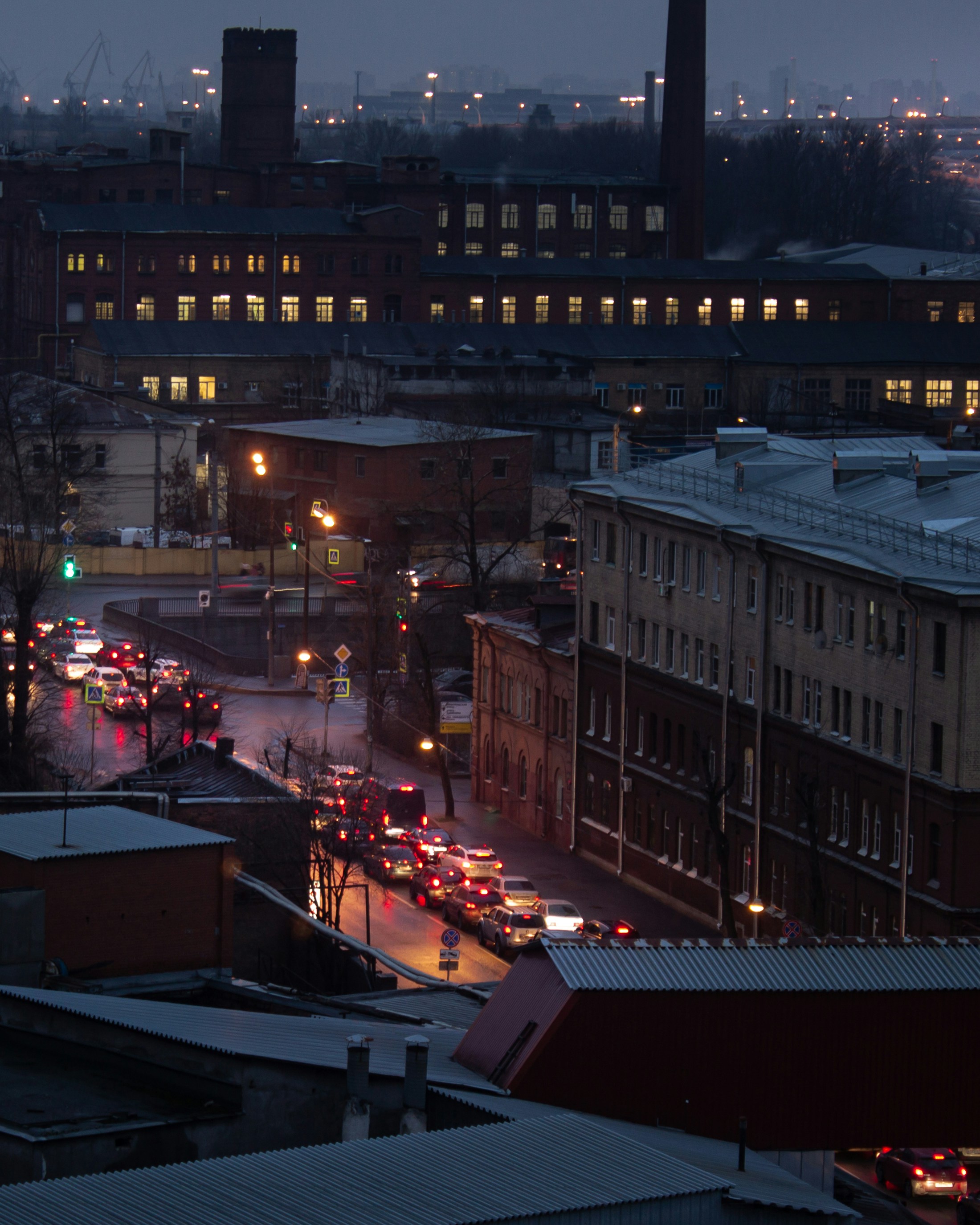 cars parked on the side of the road near buildings during night time