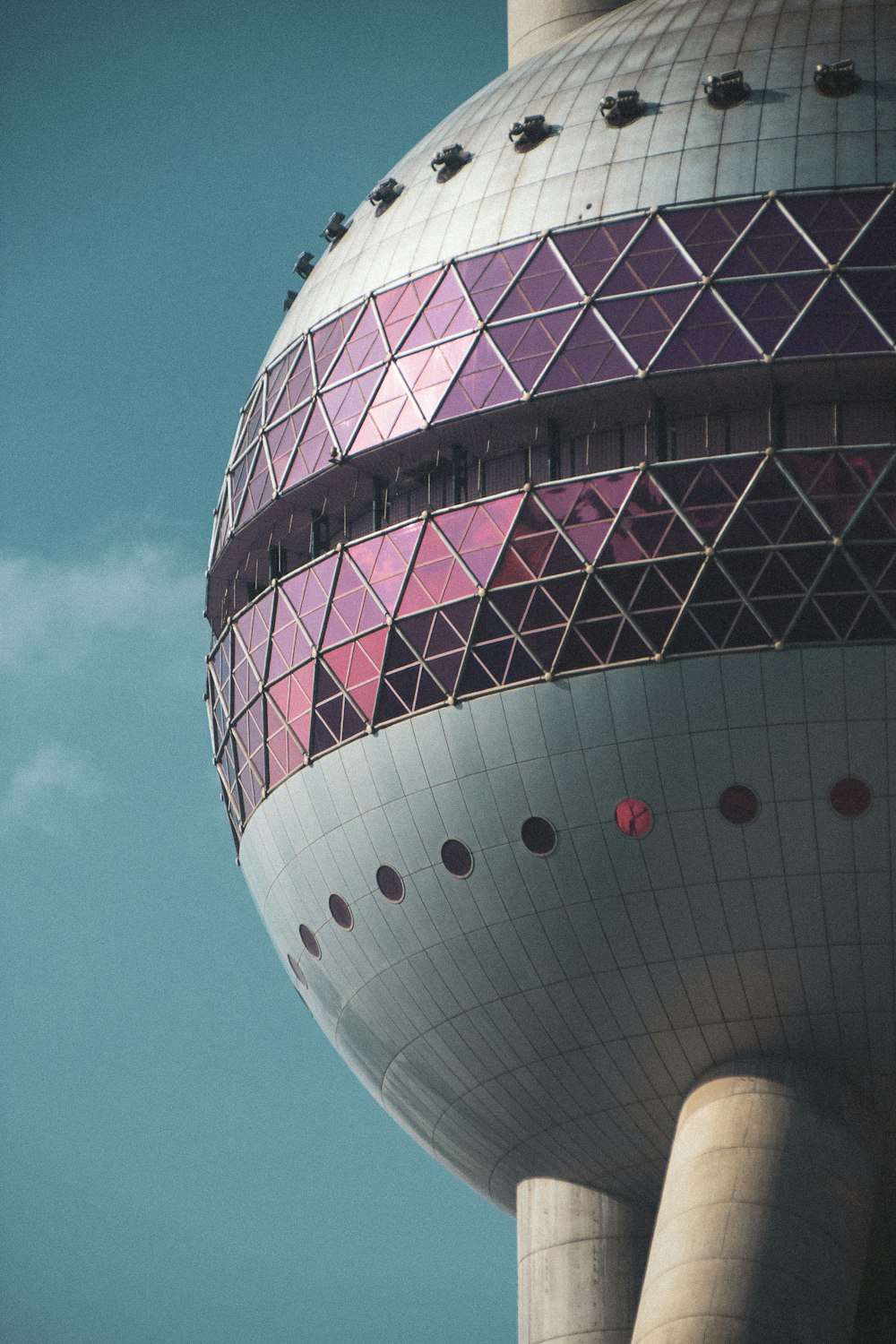 white and purple round building under blue sky during daytime