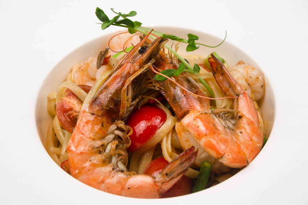 cooked shrimp with sauce on white ceramic plate