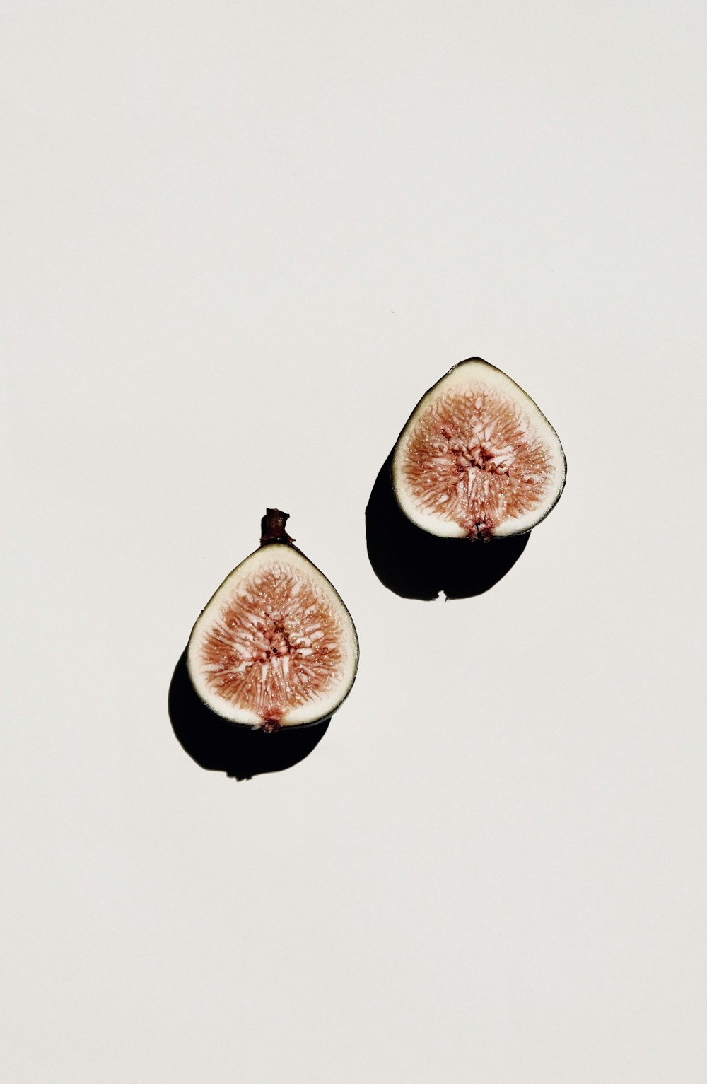 sliced pomegranate fruit on white surface