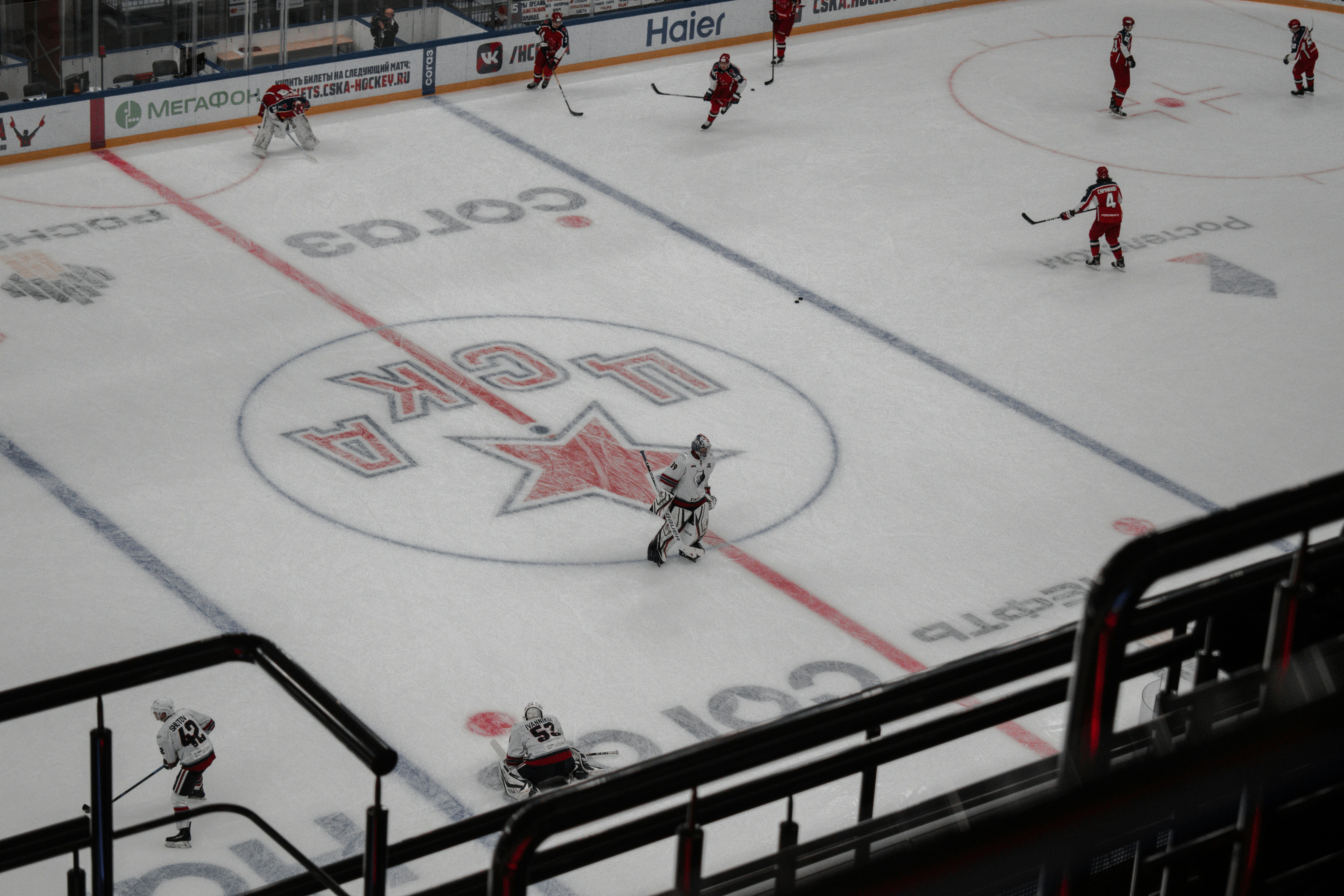 people playing ice hockey on ice field