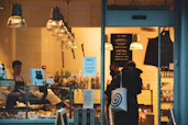 A cozy counter at What The Schnitz with a friendly staff member ready to take your pickup order.