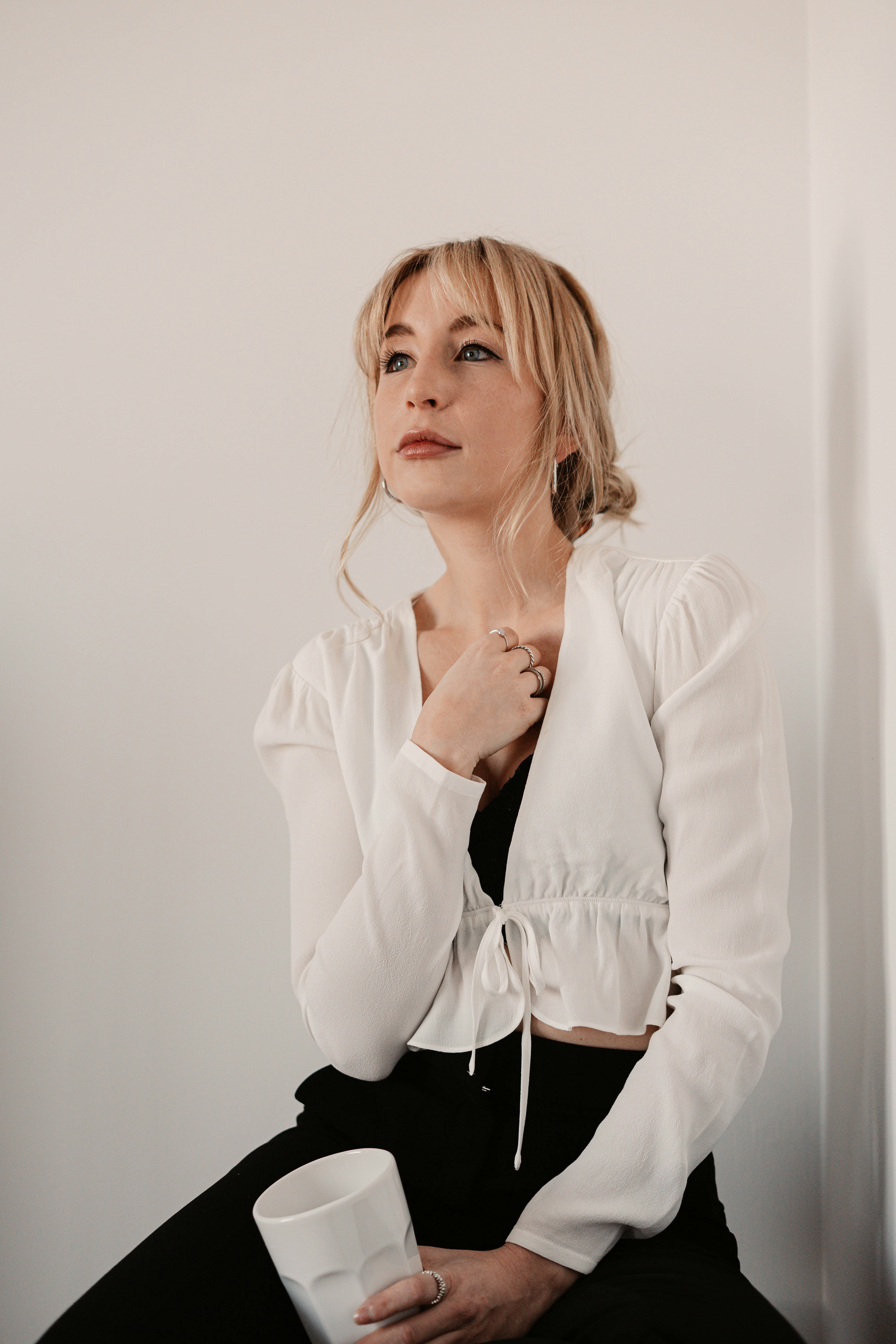 woman in white blazer and black skirt