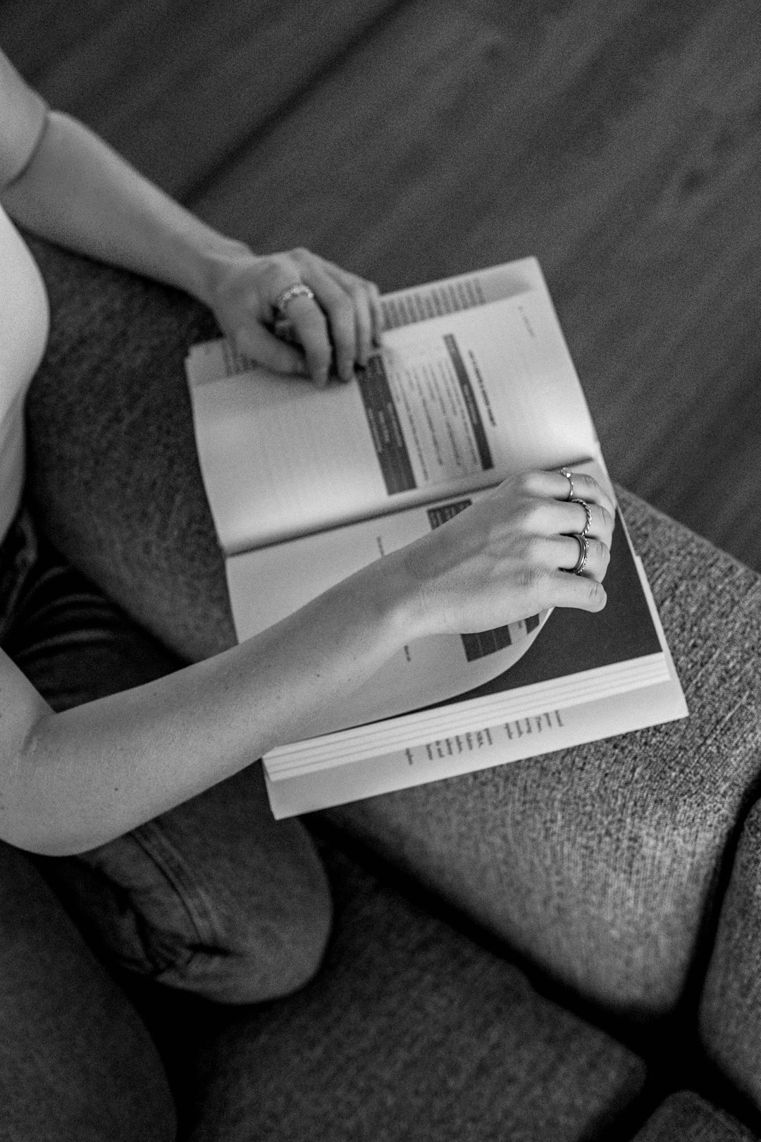 grayscale photo of person reading book